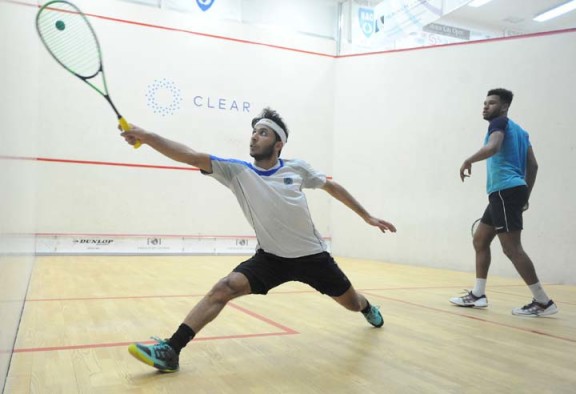 Abdulla Mohd Al Tamimi of Qatar (left) stretches for a backhand in his epic, 5-game loss to Richie Fallows of England. (Photo by Bryan Mitchell/BAC)